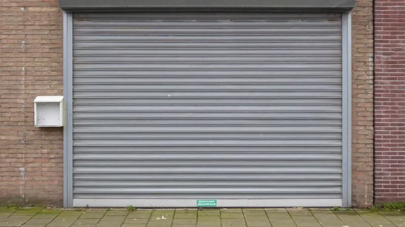 Closed grey metal roll-up steel shutter door