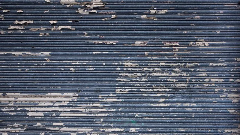 Close-up of a rusty weathered steel roll-up door