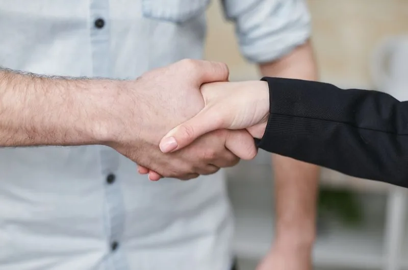 Technician shaking hands with a satisfied customer