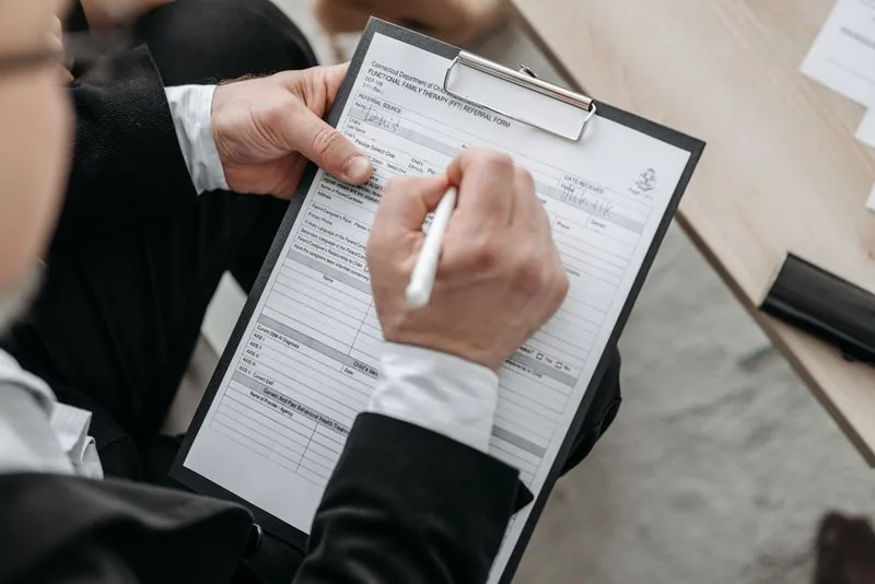 Technician writing a transparent written estimate on a clipboard